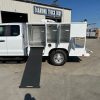Diamond 8-foot animal transport body with stainless steel cages, A/C roof ducting, LED lighting, and rear step bumper installed on a Ford chassis.