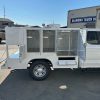 Diamond 8-foot animal transport body with stainless steel cages, A/C roof ducting, LED lighting, and rear step bumper installed on a Ford chassis.
