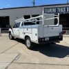 Custom white steel service body on Chevy 3500 with ladder rack and pull-out drawers
