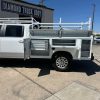 Custom white steel service body on Chevy 3500 with ladder rack and pull-out drawers