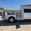 Custom white steel service body on Chevy 3500 with ladder rack and pull-out drawers
