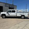 Custom white steel service body on Chevy 3500 with ladder rack and pull-out drawers