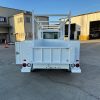 Ford E-Transit Custom Service Body with compartments, shelving, and 1300 lb lift gate