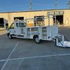 Ford E-Transit Custom Service Body with compartments, shelving, and 1300 lb lift gate