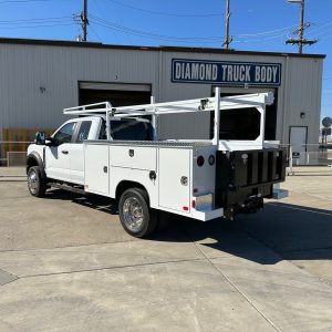 9-foot Diamond service body mounted on a 2026 Ford F-450 60-inch CA chassis, painted white with open-top compartments and aluminum diamond overlay lids.”