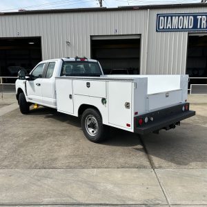 Enclosed top service body with long horizontal curb side compartment and stainless steel T-handle locks