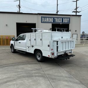Rear view of AB-AC6-96-SACCO2 animal control truck showing stainless steel cage doors, dead animal compartment, LED lighting, and Tommy Gate liftgate