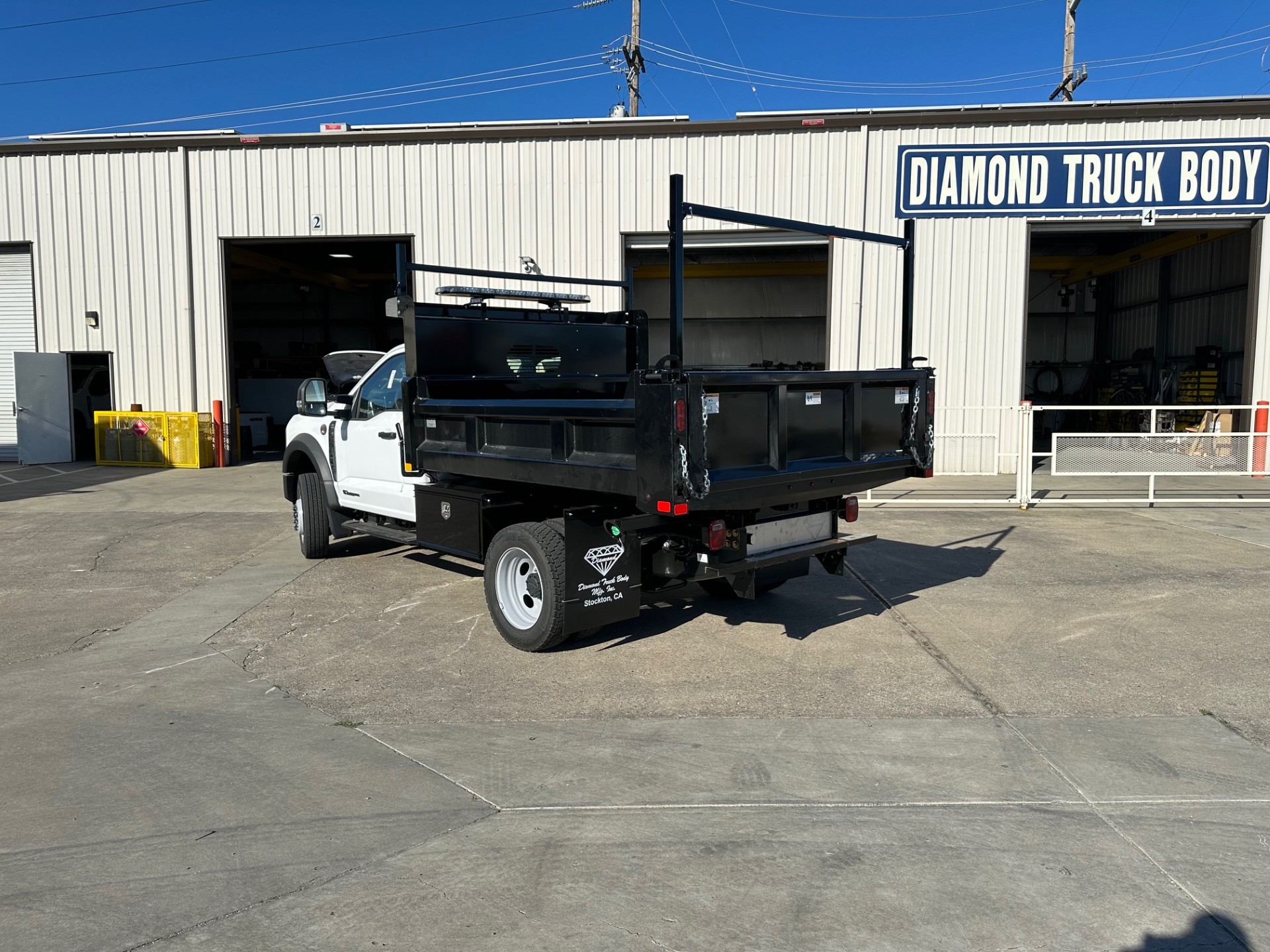 Rugby dump body with rigid steel sides and powder coated black finish