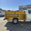custom yellow service body with tool storage